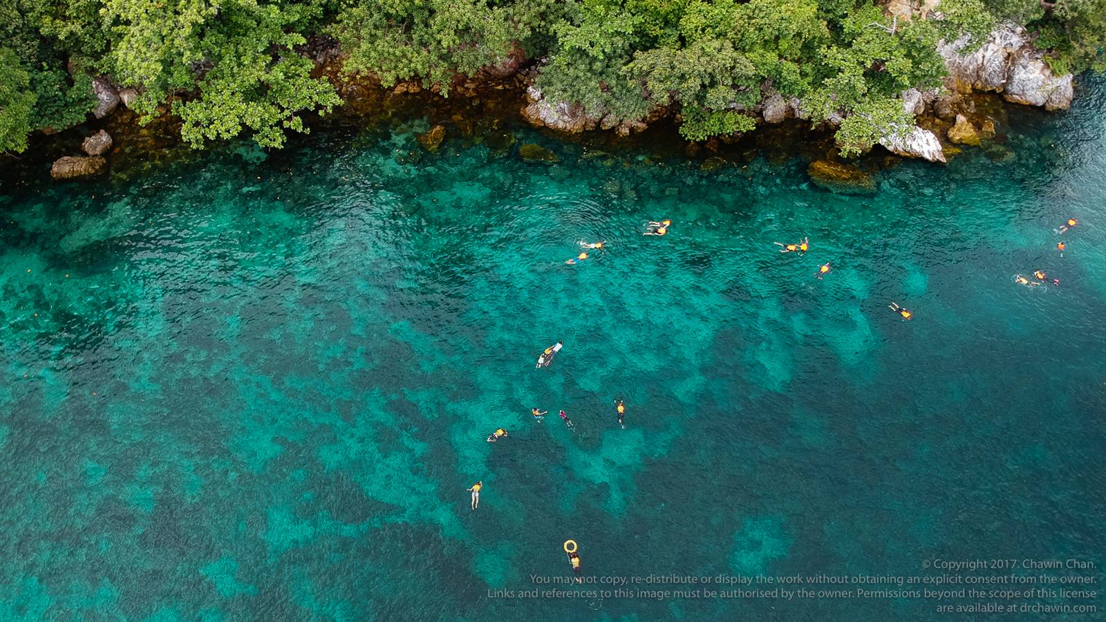 Aerial view of swimmers over a turquoise reef, Myanmar